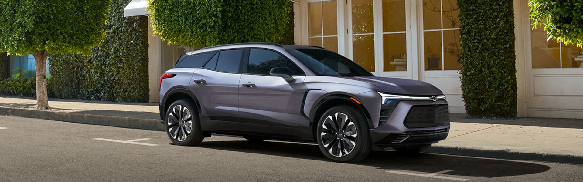 A sleek gray electric Chevrolet Blazer-EV SUV parked on a city street.