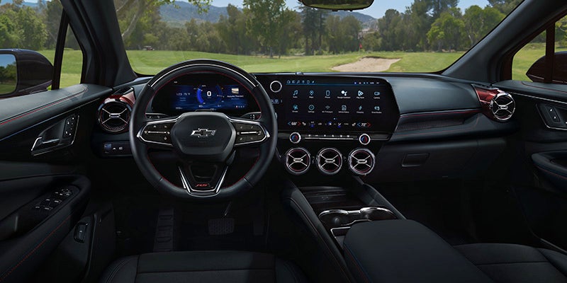 The interior dashboard and steering wheel of the Blazer EV
