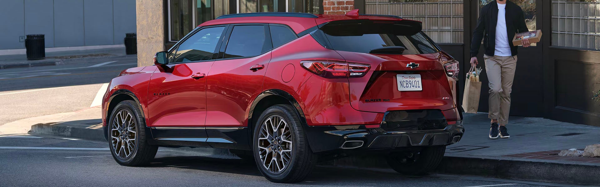 Rear view of a red Chevrolet Blazer RS SUV parked on a city street
