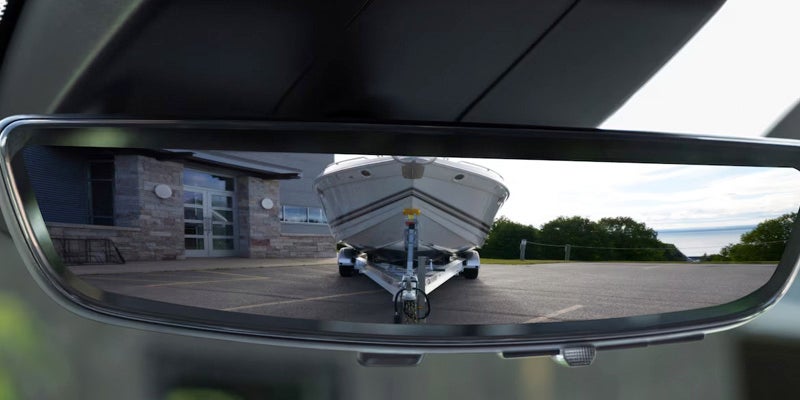 Digital rearview mirror displaying a clear view of a boat being towed