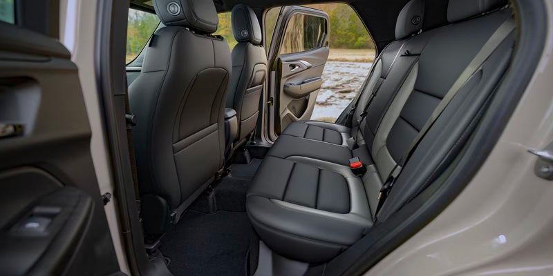 Black leather interior of a car's rear passenger seating and cargo area